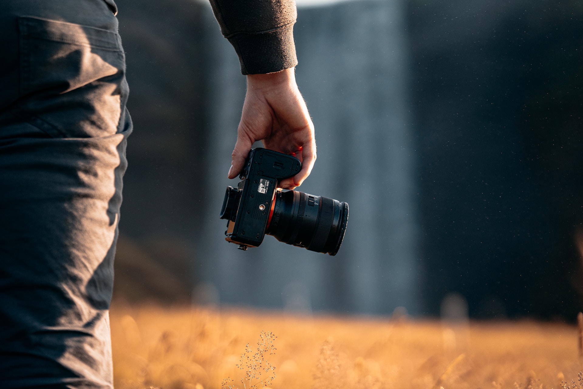 Photo of someone holding a camera by Spenser Sembrat